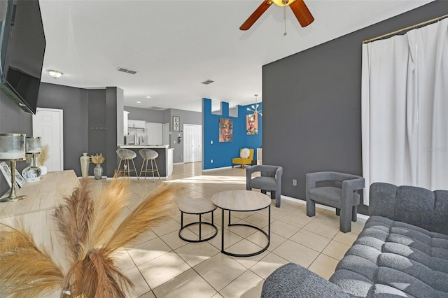 living room with light tile patterned floors and ceiling fan