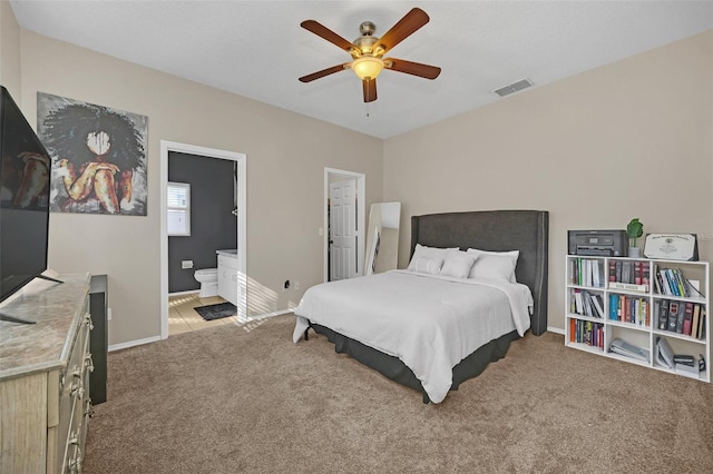 bedroom featuring ensuite bathroom, ceiling fan, and light carpet