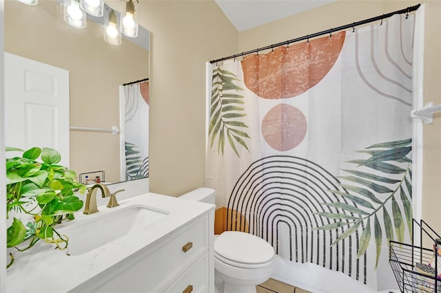 bathroom featuring tile patterned flooring, vanity, and toilet