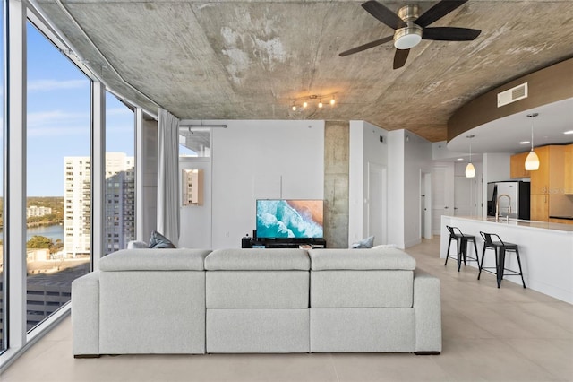 living room featuring ceiling fan and sink