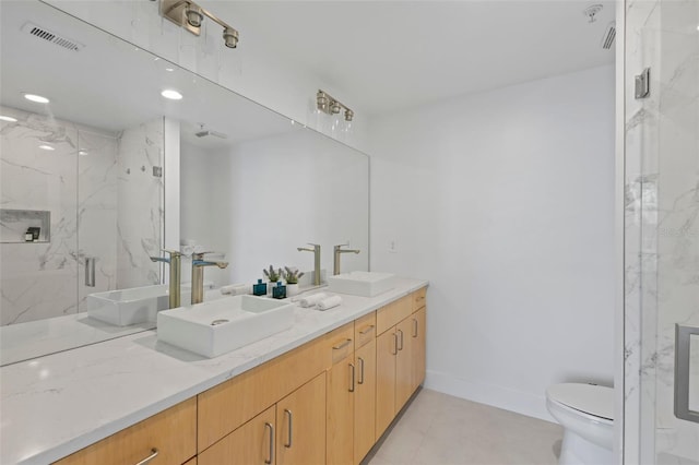 bathroom featuring vanity, toilet, and a shower with shower door