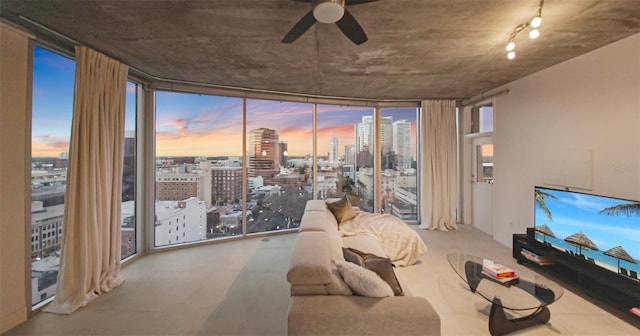 living room with floor to ceiling windows and ceiling fan