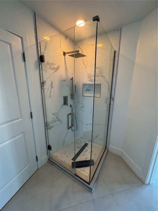 bathroom with tile patterned flooring and walk in shower