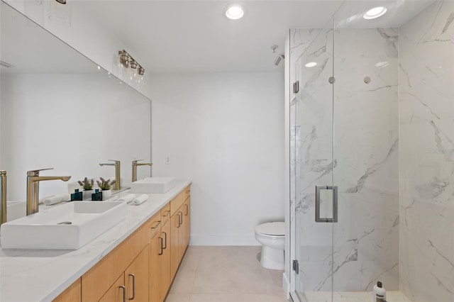 bathroom featuring an enclosed shower, vanity, toilet, and tile patterned floors