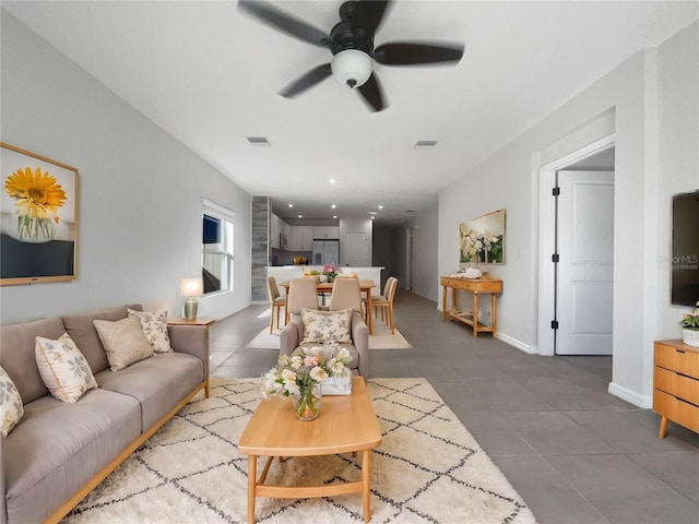 tiled living room featuring ceiling fan