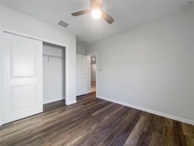 unfurnished bedroom with a closet, dark hardwood / wood-style floors, and ceiling fan