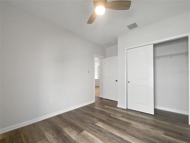 unfurnished bedroom with ceiling fan, a closet, and dark hardwood / wood-style floors