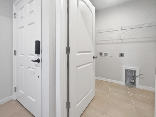 washroom featuring hookup for an electric dryer, light tile patterned flooring, and washer hookup