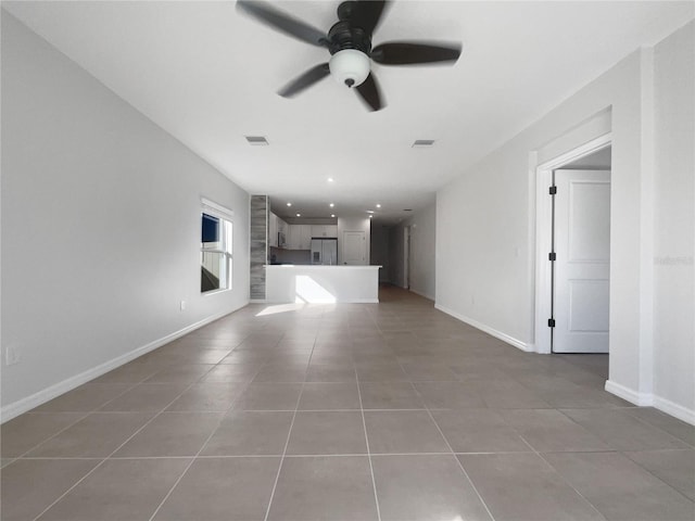 unfurnished living room with tile patterned flooring and ceiling fan