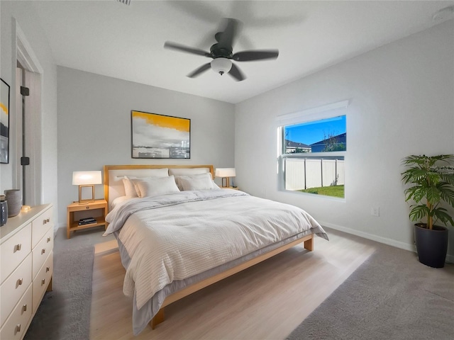 bedroom with ceiling fan and hardwood / wood-style flooring