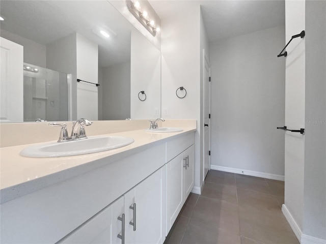 6223 Springmont Loop, Palmetto, FL 34221 - full bathroom featuring double vanity, baseboards, tile patterned flooring, and a shower