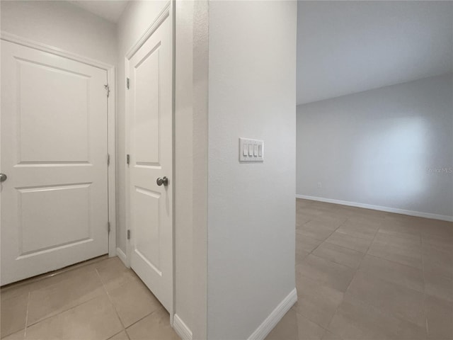 corridor with light tile patterned floors