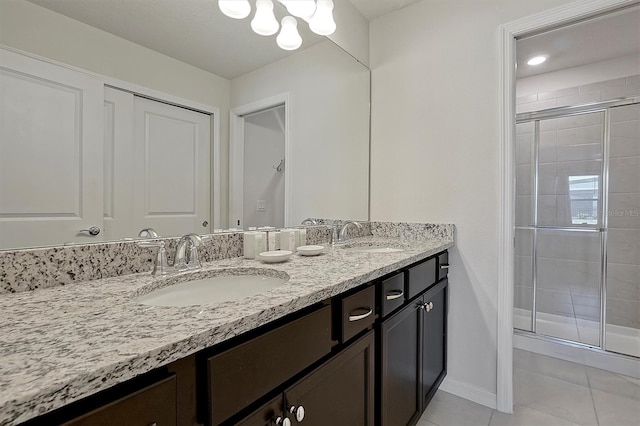 bathroom featuring tile patterned floors, vanity, and a shower with door