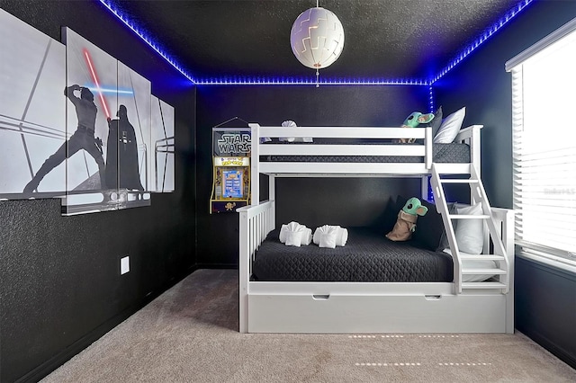 bedroom featuring carpet flooring and a textured ceiling