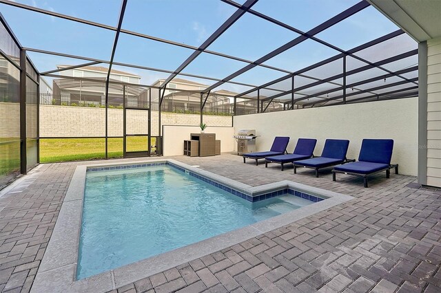 view of swimming pool with glass enclosure and a patio