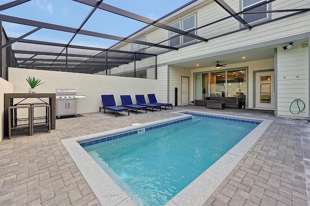 view of pool with ceiling fan, a lanai, an outdoor living space, area for grilling, and a patio