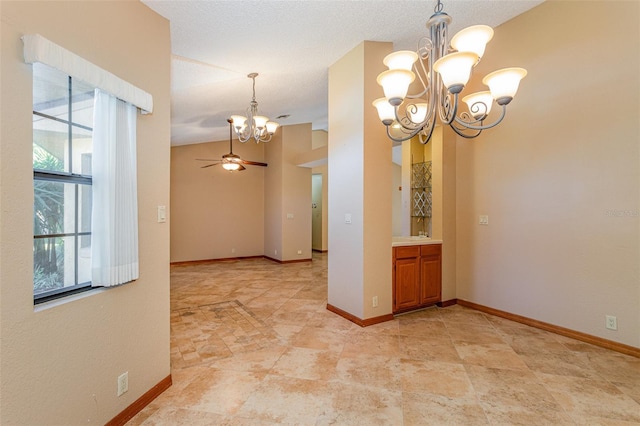 unfurnished room featuring ceiling fan with notable chandelier