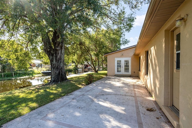 exterior space featuring french doors and a water view