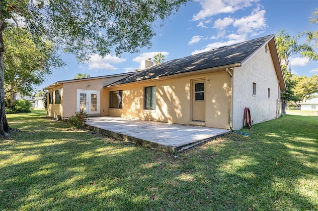 back of house featuring a yard, a patio, and french doors