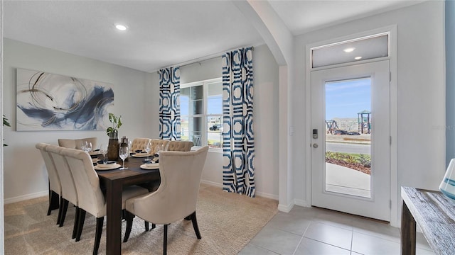 tiled dining room with a healthy amount of sunlight