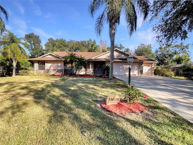 single story home featuring a front lawn and a garage