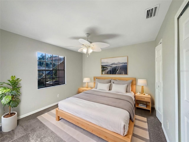 bedroom with dark colored carpet and ceiling fan