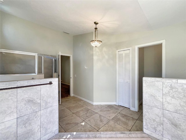 bathroom with tile patterned flooring and lofted ceiling