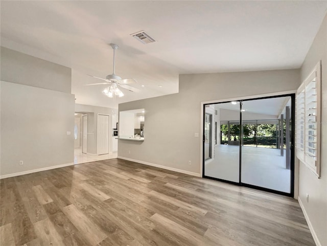 unfurnished living room with ceiling fan, lofted ceiling, and hardwood / wood-style flooring