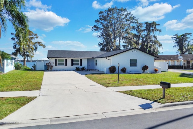 ranch-style home featuring a front yard