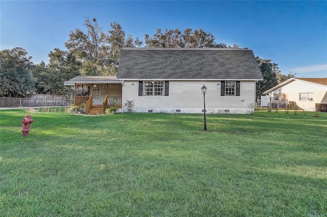 rear view of house with a yard and a porch