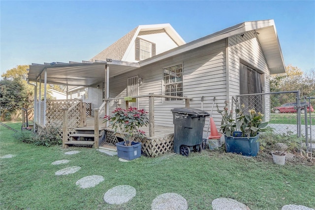 view of property exterior with a deck and a yard