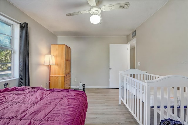 bedroom featuring ceiling fan and light hardwood / wood-style flooring