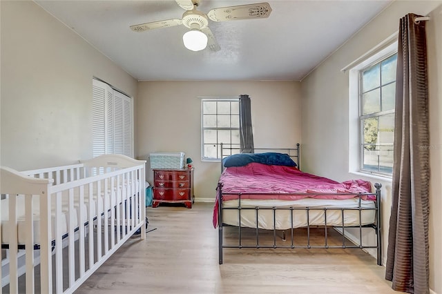 bedroom with baseboards, wood finished floors, and ceiling fan