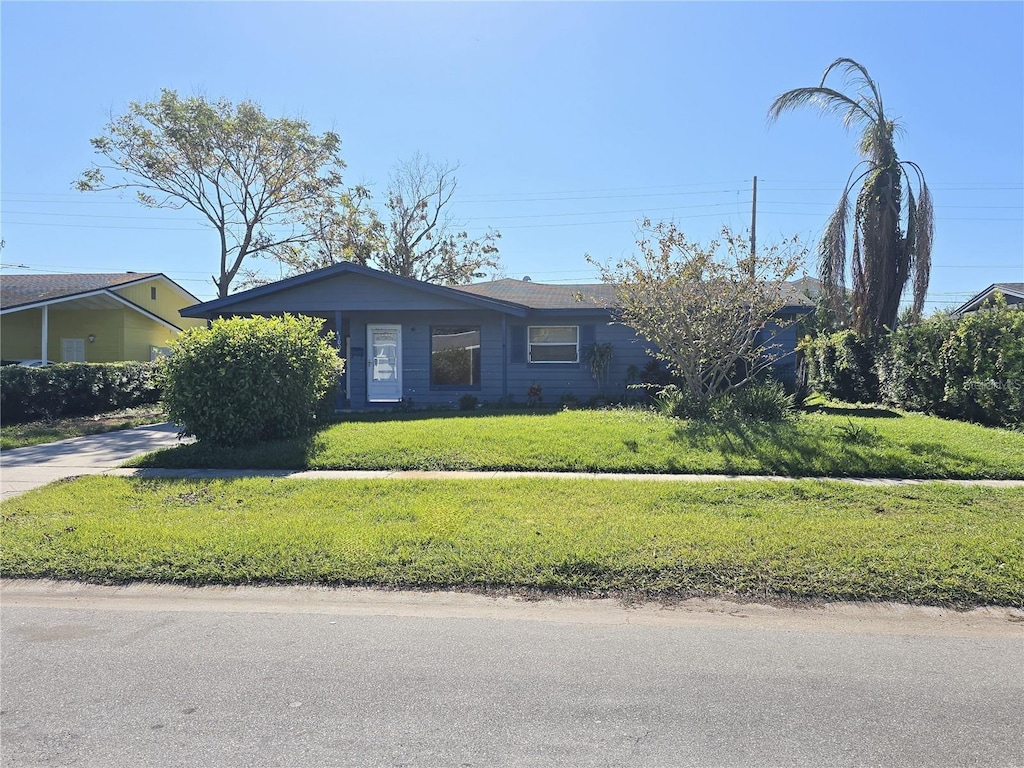 ranch-style home with a front lawn