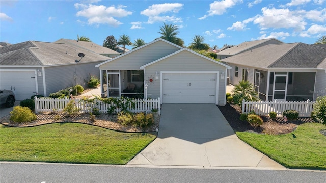 ranch-style home featuring a front yard, a garage, and a sunroom