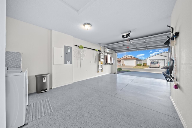 garage with washer / dryer, electric panel, and a garage door opener