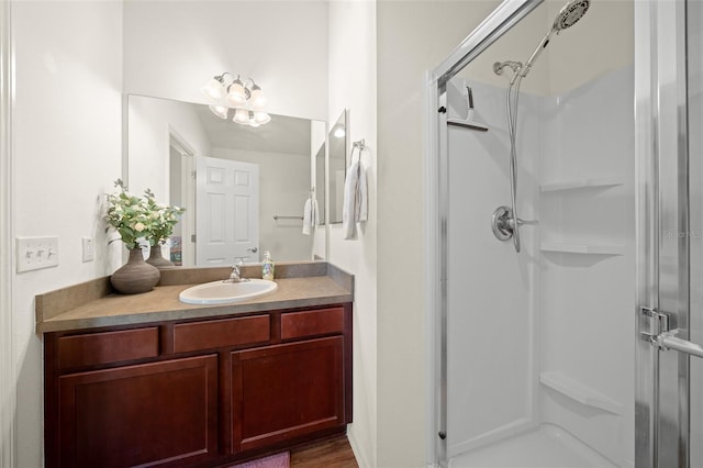 bathroom featuring vanity, wood-type flooring, and walk in shower