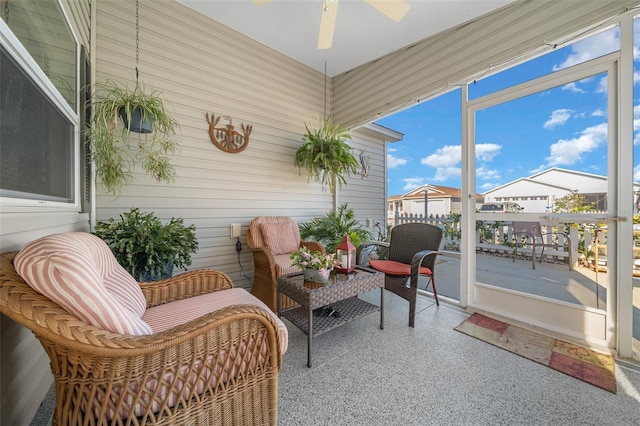 sunroom / solarium featuring ceiling fan