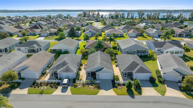 birds eye view of property with a water view