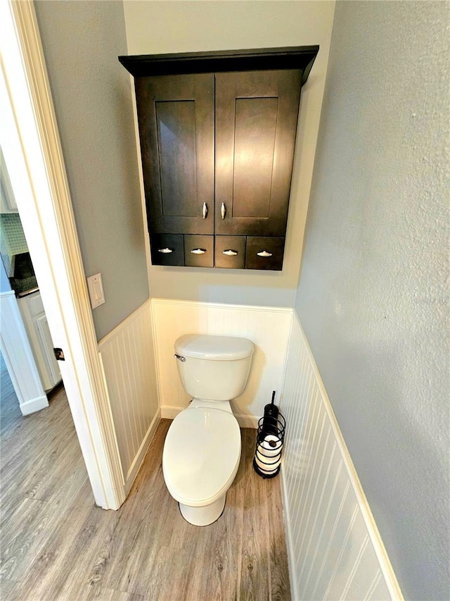 bathroom featuring toilet and wood-type flooring