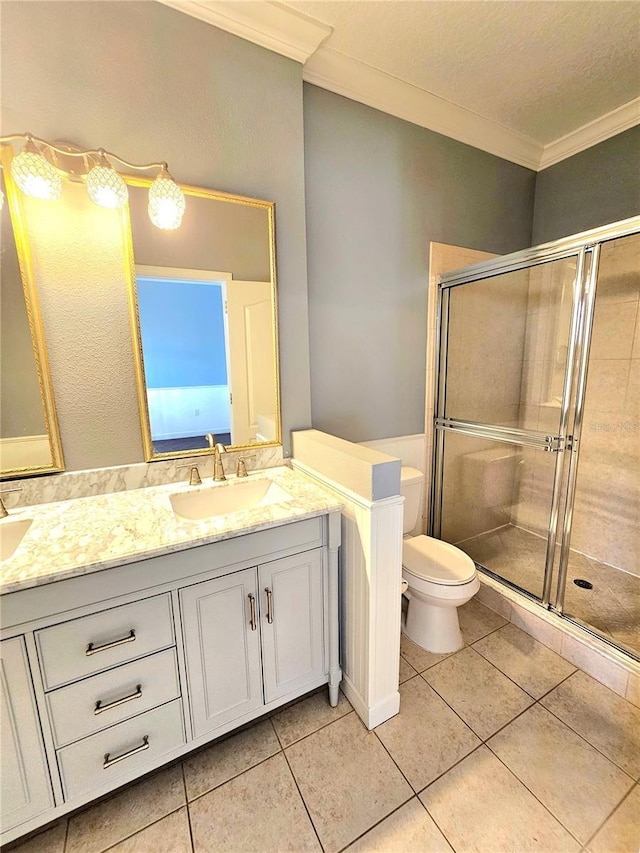 bathroom featuring tile patterned floors, an enclosed shower, toilet, vanity, and ornamental molding