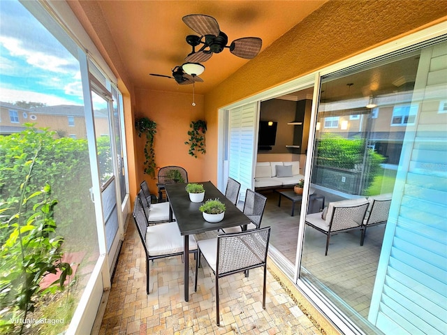 sunroom featuring ceiling fan