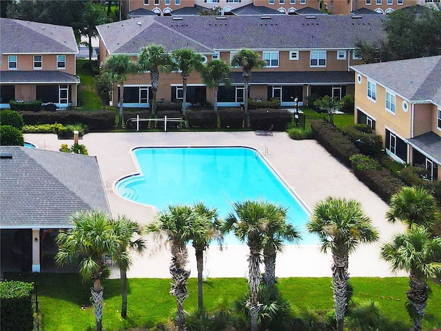 view of swimming pool with a patio area and a yard