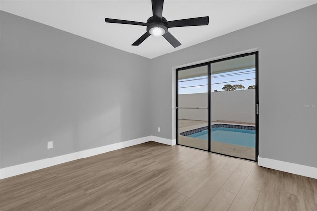 spare room featuring ceiling fan and light hardwood / wood-style flooring