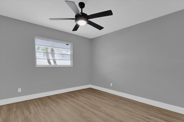 spare room with ceiling fan and light wood-type flooring