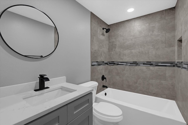 full bathroom with vanity, tiled shower / bath combo, and toilet