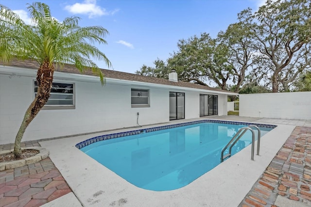 view of swimming pool with a patio area