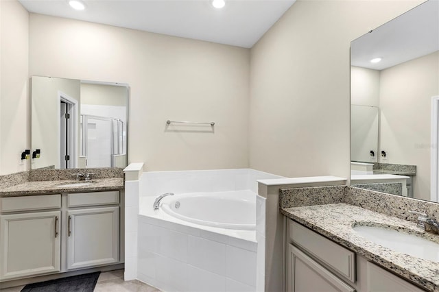 bathroom featuring tile patterned floors, vanity, and separate shower and tub