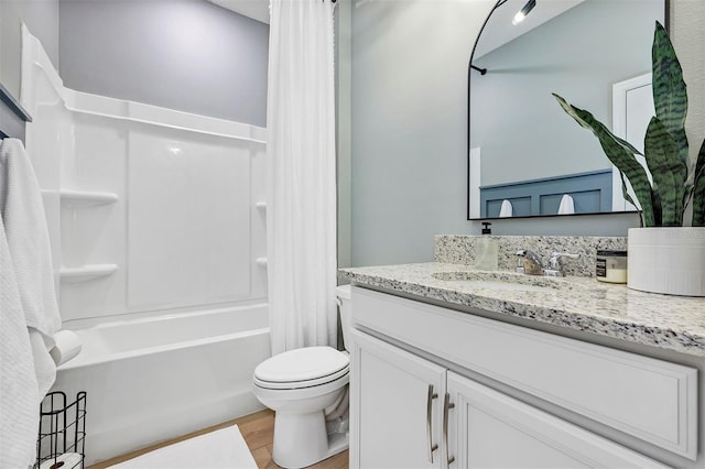 full bathroom with shower / tub combo with curtain, vanity, wood-type flooring, and toilet