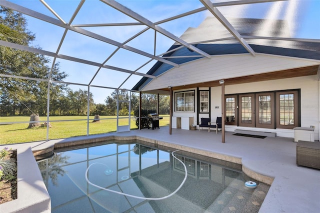 view of swimming pool with glass enclosure, french doors, a yard, grilling area, and a patio